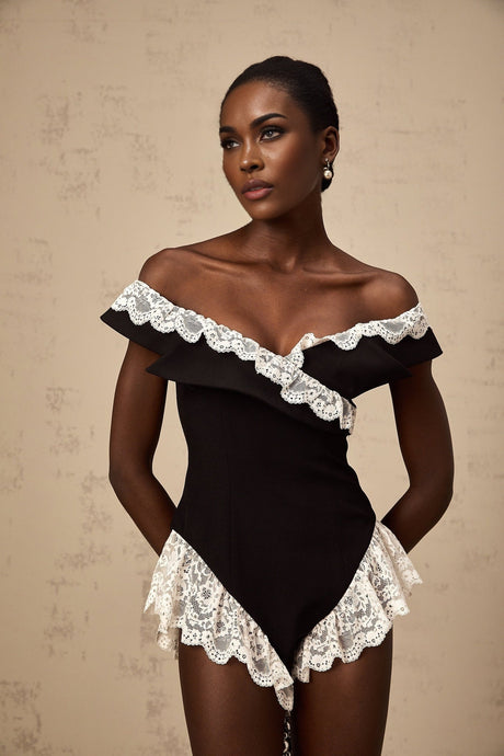 Woman wearing black bodysuit with lace trim detailing