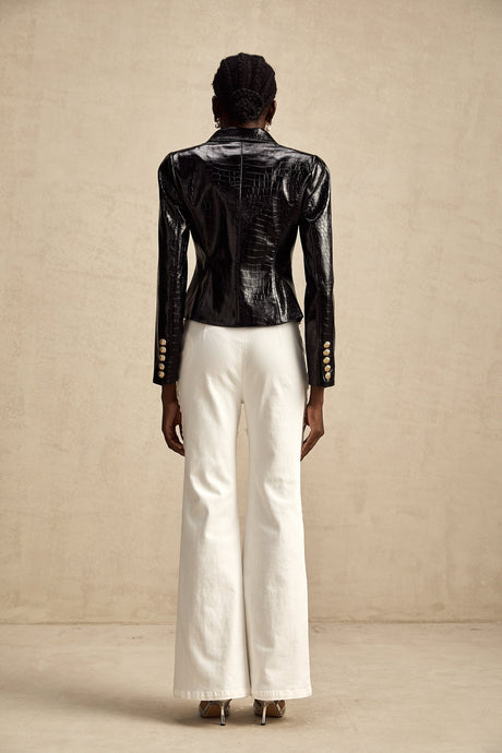 Woman wearing black leather jacket with cinched waist