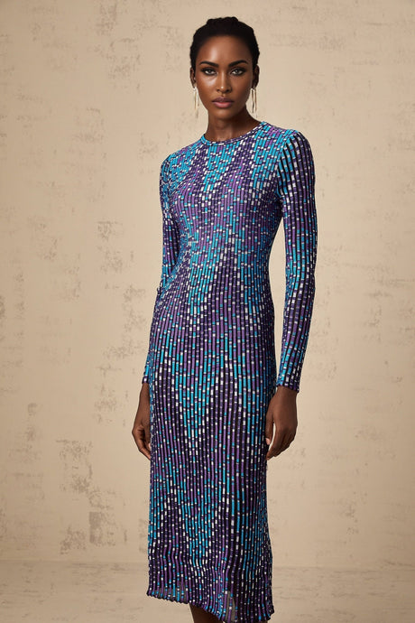 Woman wearing blue and white zigzag pattern knitted midi dress with long sleeves
