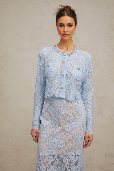 Woman wearing blue floral lace matching top and skirt set called Ariane