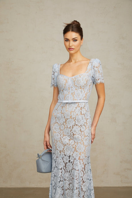 Woman wearing blue floral lace midi dress with boned bodice and fitted silhouette