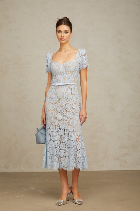 Woman wearing blue floral lace midi dress with boned bodice and fitted silhouette