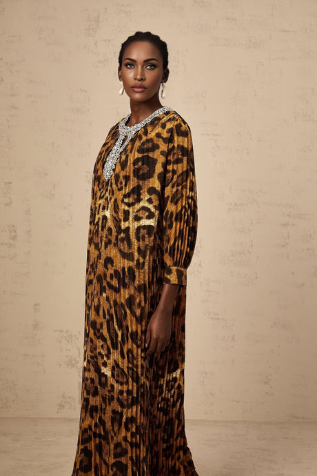 Woman wearing brown leopard print midi dress with embellishments and long sleeves