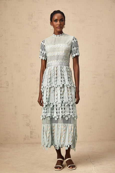 Woman wearing green midi dress with floral embroidery pattern