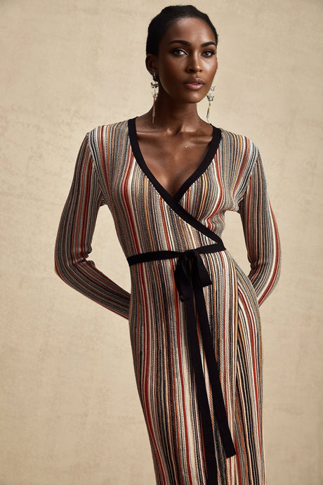Woman wearing long sleeve striped metallic midi dress with wrap design