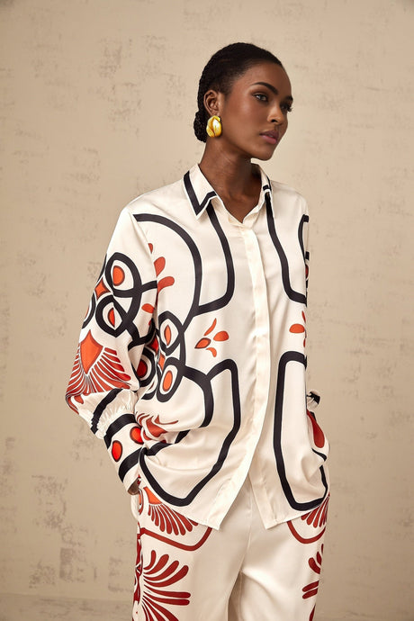 Woman wearing matching shirt and trousers set with colorful graphic print pattern