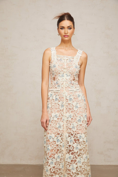 Woman wearing white Aline midi dress with floral lace pattern sleeveless design and scoop neckline