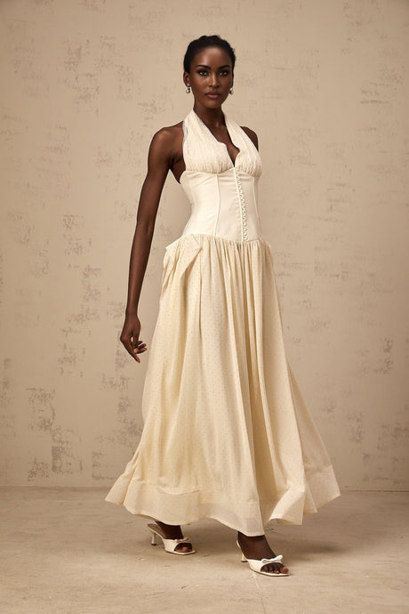 Woman wearing white halterneck tulle midi dress with flowy skirt and fitted bodice