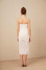 Woman wearing white lace midi dress with crystal embellished bustier top and fitted silhouette