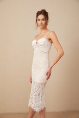 Woman wearing white lace midi dress with crystal embellished bustier top form fitting silhouette and delicate floral lace pattern