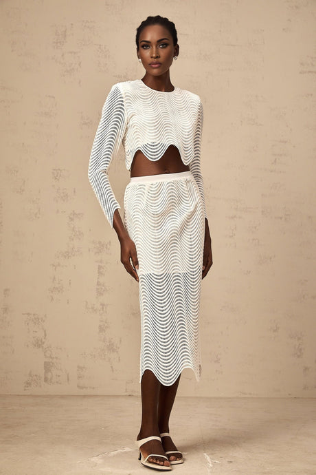 Woman wearing white twopiece outfit consisting of wavy woven top and matching skirt called Constance