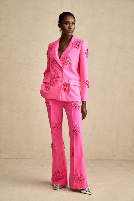 Young girl wearing a pink floral jacket and matching trousers set named AmelieRose