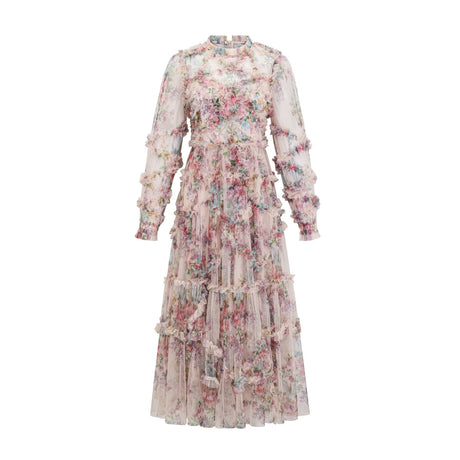 Young woman wearing a floral midi dress with ruffled tulle skirt and delicate floral pattern standing against a plain background